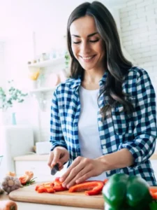 Portrait of Lauren, smiling and cocking, finger licking recipes.