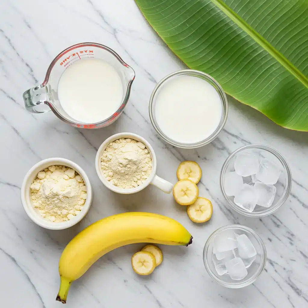 Banana Bariatric Shake Recipe (3-Ingredient!) 3 Ingredients for a Banana Bariatric Shake Recipe, including banana, protein powder, milk, and ice, laid out on a marble surface.