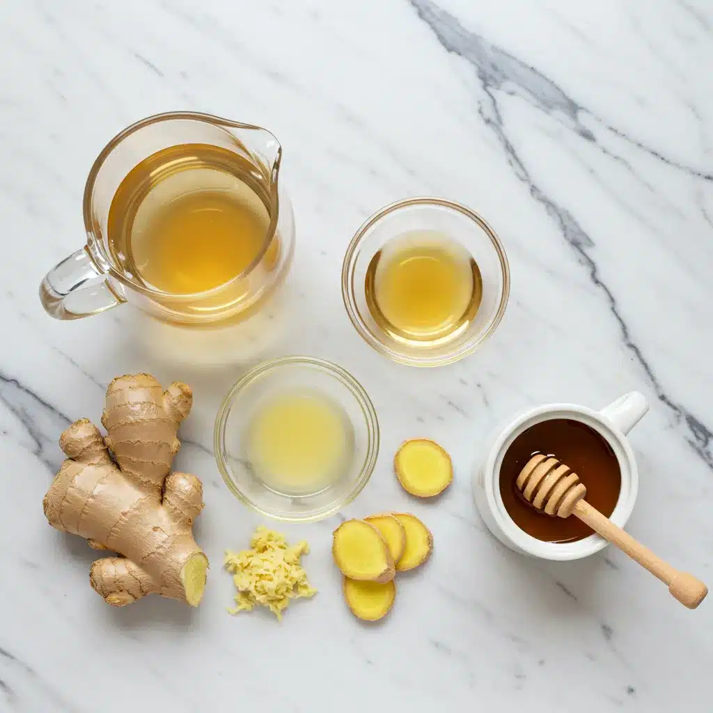 The Ultimate Natural Mounjaro Recipe (4 Ingredients for Weight Loss) 3 An overhead view of the fresh ingredients for the Natural Mounjaro Recipe: ginger, lemon, honey, and prepared tea.