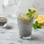 chia seed water recipe in a clear glass with a lemon slice garnish