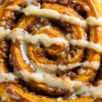 Pumpkin Cinnamon Rolls: The Ultimate Gooey & Fluffy Recipe The soft, unbaked pumpkin dough for cinnamon rolls after its first rise in a glass bowl, looking puffy and doubled in size.