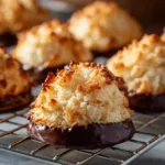 Chocolate Dipped Coconut Macaroons: The Easiest Recipe! A close-up view of a golden-brown baked coconut macaroon before being dipped in chocolate, highlighting its chewy, shredded coconut texture.