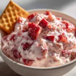 Valentine Strawberry Dessert Dip: A 5-Minute Romantic Treat A close-up shot of the creamy, fluffy texture of the strawberry cream cheese dip in a white bowl.
