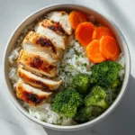 Chicken and Veggie Rice Bowl (with a Secret Sauce!) A close-up shot of the healthy chicken and vegetable stir fry mixture in a skillet, showcasing the vibrant colors of the broccoli and carrots.