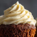 A close-up macro shot showing the incredibly moist and tender crumb of a spiced gingerbread cupcake.