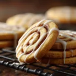 The Best Classic Holiday Sugar Cookies Recipe A baker rolling out chilled sugar cookie dough on a floured surface before cutting it into holiday shapes.