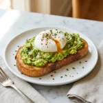 Avocado Toast with Poached Egg: The Ultimate Guide A close-up of avocado toast with a perfectly poached egg on top, garnished with red pepper flakes.