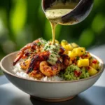 Shrimp and Avocado Bowl (Quick & Healthy Recipe) A close-up shot of seasoned raw shrimp being tossed in a bowl with spices before cooking for the healthy shrimp bowl.