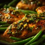 A close-up view of the slow cooker chicken and green beans, with steam rising from the dish, highlighting the glossy, thick glaze on the chicken.