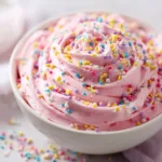 A close-up shot of the creamy funfetti dip, showing its light and fluffy texture, packed with colorful Easter sprinkles.
