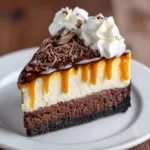 A close-up shot of the fudgy brownie base and creamy cheesecake filling of the caramel brownie cheesecake.