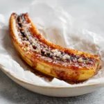 Top view of Air Fryer Caramelized Bananas dusted with cinnamon powder and coarse sugar crystals.