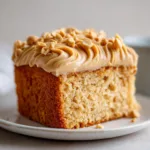 Ingredients laid out for a peanut butter cake featuring flour, sugars, butter, creamy peanut butter, and buttermilk.