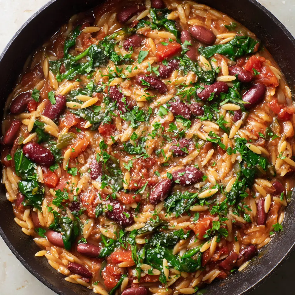 The Ultimate One-Pot Mediterranean Orzo Skillet 2 A serving of One-Pot Mediterranean Orzo generously garnished with finely grated parmesan and coarse chopped parsley.