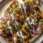 Sliced chicken thighs with a golden-yellow and reddish-brown spice crust for our Chicken Shawarma Recipe.