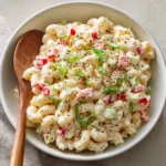 Smartphone photo of Dolly Parton Macaroni Salad showing pale yellow noodles and thick glossy dressing. (Dolly Parton Macaroni Salad)