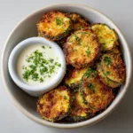 Close-up of Air Fried Zucchini Bites in a white bowl showing the toasted panko breading and charred edges.