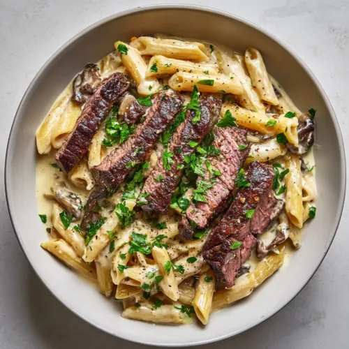 Creamy Steak Pasta with Garlic Cream Sauce and Pan-Seared Ribeye
