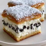 Handheld smartphone photo of a square-cut Ricotta Cannoli Square on a white plate.