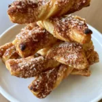 Close-up of tight spiral Air Fryer Cinnamon Sugar Twists with visible dark cinnamon and granulated sugar granules.