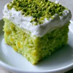 Close-up of Pistachio Pineapple Cake highlighting the soft crumb texture and crushed pineapple bits.