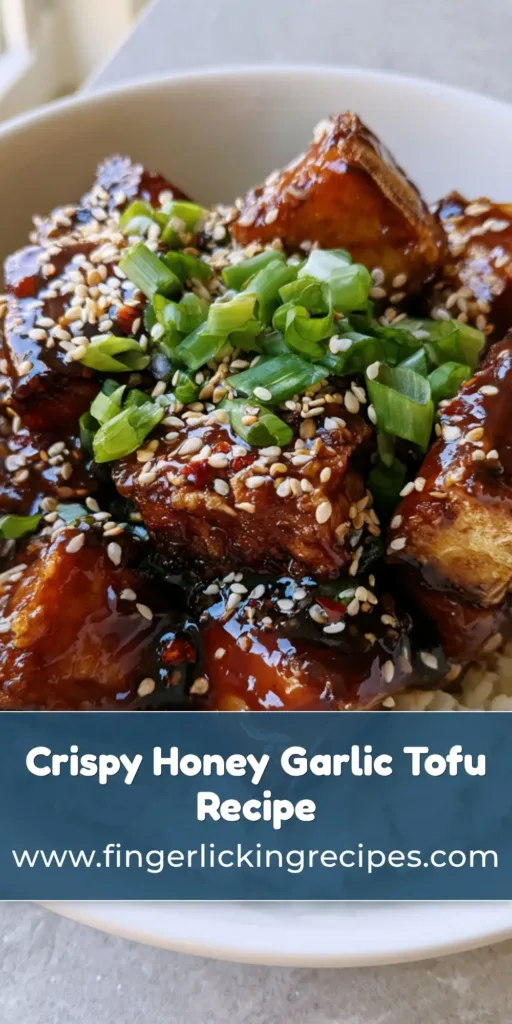 Honey Garlic Tofu: Crispy Pan-Seared Cubes in a Glossy Umami Glaze 7 A close-up vertical shot of Honey Garlic Tofu in a white bowl with green scallions and sesame seeds over steamed rice.