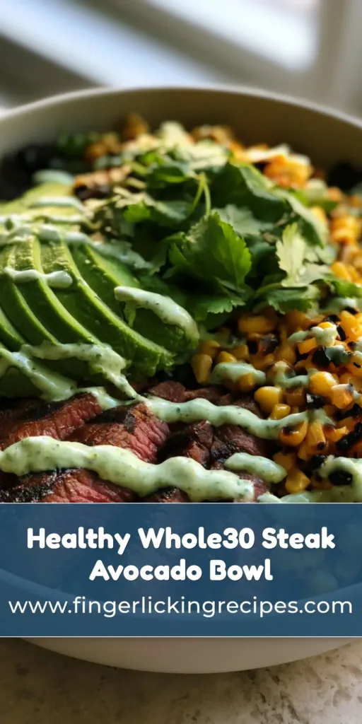 A close-up of a Whole30 Steak and Avocado Bowl featuring seared steak, avocado slices, and charred corn kernels with a cilantro cream drizzle.