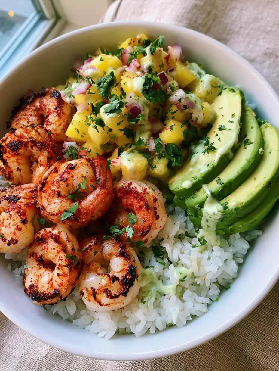 Tropical Shrimp Rice Bowl with Charred Pineapple Salsa and Avocado Crema 4 Close-up of succulent pan-seared shrimp with red spices and charred edges in a Tropical Shrimp Rice Bowl.