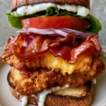 Loaded Chicken Club Sandwich: The Ultimate Crispy Sourdough Recipe Close up view of the crispy, craggy texture of the breaded chicken tenders inside the Loaded Chicken Club Sandwich.