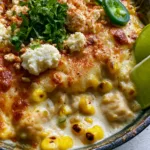Close-up of succulent chicken breast cubes in a creamy sauce with charred corn and melted cheese. (Street Corn Chicken Casserole)