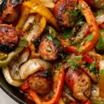 Sausage and Peppers Skillet: The Ultimate One-Pan Italian Feast Top-down view of a Sausage and Peppers Skillet showing juicy sausage rounds and sautéed bell peppers with visible herbs. (Sausage and Peppers Skillet)